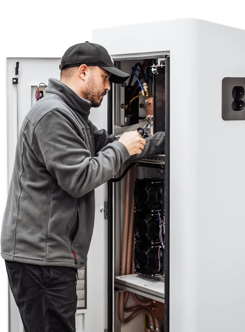 Technician working on the interior of an EV charging station