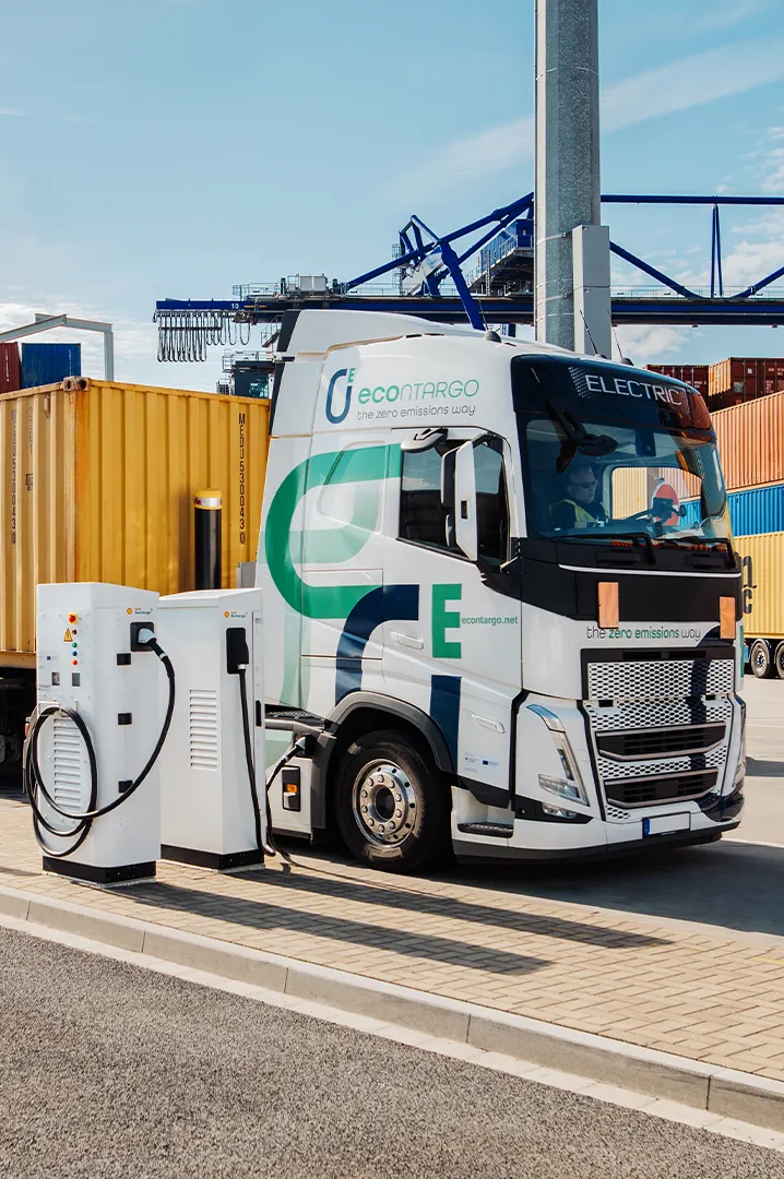 sbrs-industries-heavy-duty-trucks Electric truck charging at a public station on a logistics site.