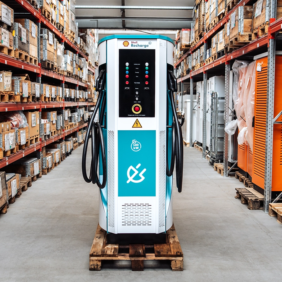 Front view of the Flex180 charging station with dual cable holders, positioned on a pallet in a warehouse setting.