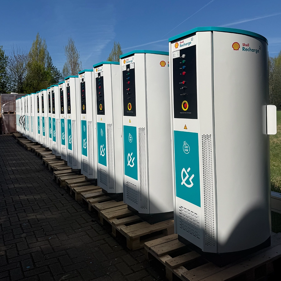 Row of Flex180 DC charging stations positioned outdoors on wooden pallets under a clear sky