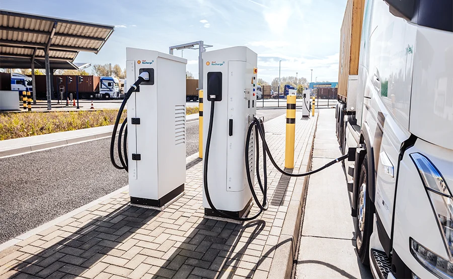 Electric truck charging at white Shell Recharge stations in a depot environment